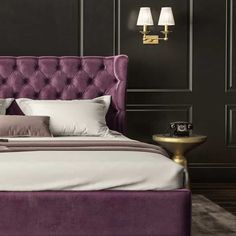 a bed with purple upholstered headboard and two lamps on either side of it