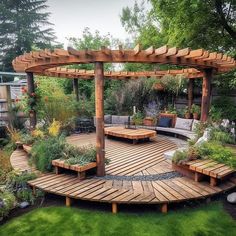 a wooden deck surrounded by lots of greenery and plants in the middle of a yard