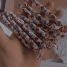 a hand holding several matches sticks in front of a mirror