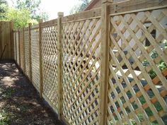 a wooden fence with lattice design on it