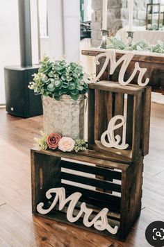 two wooden crates with mr and mrs letters on them, one holding succulents