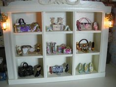 a white bookcase filled with lots of purses