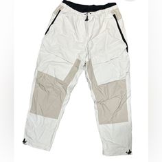 Men's Nike Sportswear Tech Pack Woven Pants. Windbreaker Material With Lots Of Pockets Drawstring On The Bottom To Scrunch To Your Liking. Mens Size Medium Sporty Khaki Parachute Pants For Outdoor Activities, Sporty Cream Sweatpants With Pockets, Sporty Beige Pants With Pockets, White Sportswear Pants With Side Pockets, White Casual Cargo Pants For Outdoor Activities, Casual White Cargo Pants For Outdoor Activities, White Casual Cargo Pants For Outdoor, White Athleisure Parachute Pants For Sports, Casual White Cargo Pants For Outdoor