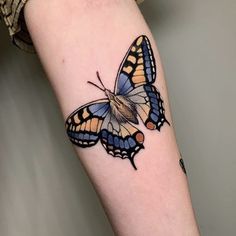 a small butterfly tattoo on the arm