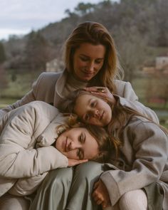 two women sitting on top of each other