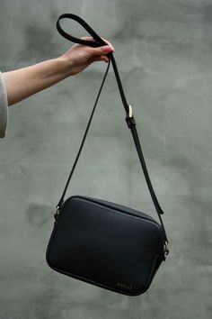 "If you need a women leather shoulder bag, pay attention to this one. Minimalistic black crossbody purse is a basic element in your look. It will be a elegant addition to your wardrobe. Black color looks great in any season. Vintage genuine leather of high quality is wear-resistant. Each seam is fixed by hand. You will wear this bag for several years. HIGH QUALITY LEATHER The matte genuine leather is of high quality, keeps shape perfectly. Leather's outer distinctive feature - vintage look. It takes bends, creases or scratches if you hook on something. Scratches are easy to remove by rubbing the place with some soft fabric or even a finger. The bag with metallic zipper-lock. There is no fabric inside the bag. The sides of the bag are reinforced with a leather split. Bag made of thick genui Classic Black Shoulder Bag With Single Strap, Evening Black Leather Camera Bag, Black Rectangular Soft Leather Camera Bag, Modern Crossbody Camera Bag For Evening, Classic Black Camera Bag For Everyday Use, Modern Evening Crossbody Camera Bag, Classic Black Everyday Camera Bag, Classic Black Camera Bag For Everyday, Sleek Black Shoulder Bag With Adjustable Strap