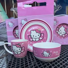 pink hello kitty dinnerware set with matching plates and cups for sale at a store