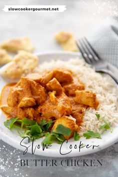 a white plate topped with rice and chicken next to silverware on top of a table