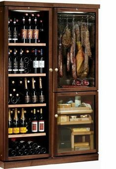 a wooden cabinet filled with lots of bottles and meat hanging from it's sides