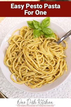 a white bowl filled with pasta on top of a table