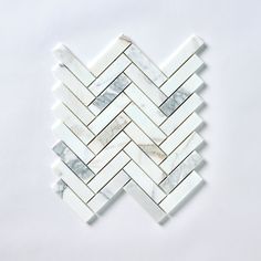 white and grey marble herringbone mosaic tile on a white background, with one corner facing the camera