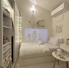 a bedroom with a bed, desk and shelves in the corner that have lights on them