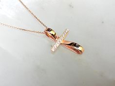 "This artistic design cross pendant is made of solid gold and decorated with natural diamonds. It contains 8-10 round brilliant cut diamonds. You can choose 14K or 18K yelllow, white or rose gold. A modern cross for women which is not only a christian symbol but also a beautiful piece of jewelry. A meaningful gift for you and your loved ones. A dainty cross which is distinguished for its modern design. DETAILS oMaterials ⁃ 14K or 18K gold Yellow, White or Rose Gold oHeight ⁃ 2.4mm / 0.94in oWidt Anniversary Diamond Pendant Cross Necklace, Diamond Cross Pendant Necklace With Accents As Gift, Diamond Crucifix Necklace With Diamond Accents, Crucifix Diamond Necklace With Diamond Accents For Gift, Crucifix Diamond Necklace With Diamond Accents As Gift, Diamond Crucifix Necklace With Accents As Gift, Diamond Cross Pendant Necklace With Pave Setting For Gift, Diamond Cross Pendant Necklace With Pave Setting, Pave Setting Diamond Cross Pendant Necklace As Gift