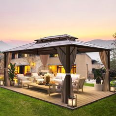 a gazebo sitting on top of a wooden deck next to a lush green field