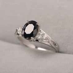 a black and white diamond engagement ring with diamonds on it