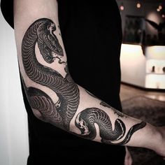 a man with a dragon tattoo on his arm