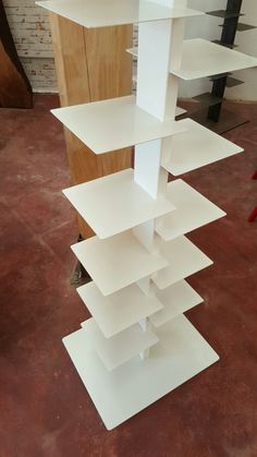 a tall white shelf sitting on top of a floor