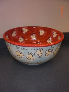 a bowl that is sitting on top of a table with mickey mouse designs in it