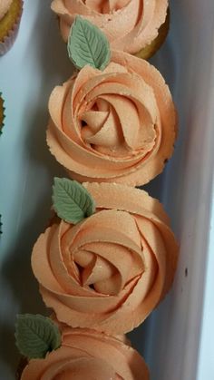 cupcakes with frosting and leaves in a box