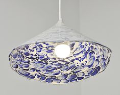 a blue and white light hanging from a ceiling