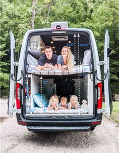 a family sitting in the back of a van