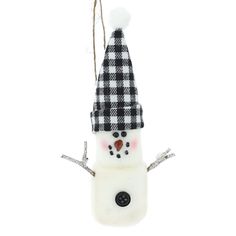 a snowman ornament with a black and white checkered hat on it