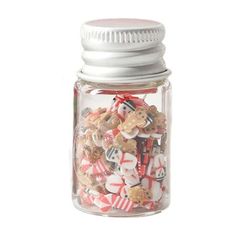 a glass jar filled with lots of different types of buttons