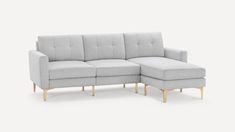 a gray couch with a wooden legs and arm rest