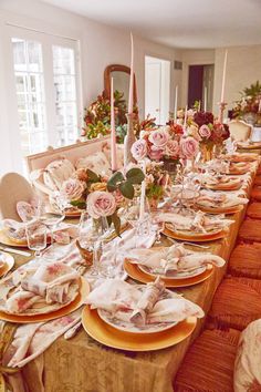 a dining room table is set with plates and place settings for dinner guests to enjoy