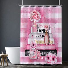 a pink shower curtain with flowers and perfume bottles on top of it next to a bath tub