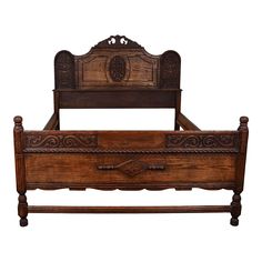 an old wooden bed with intricate carvings on the headboard and foot board, isolated against a white background