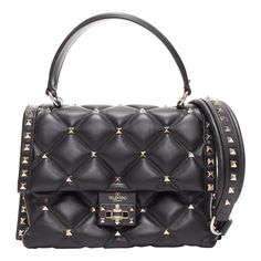 VALENTINO Candystud black nappa lambskin gold studded turnlock 2 way satchel bag Reference: TGAS/E00048 Brand: Valentino Model: Candystud Material: Leather Color: Black, Gold Pattern: Studded Closure: Turnlock Lining: Black Fabric Extra Details: Candystud Top Handle Bag in Black. This chic cross body bag is beautifully crafted of nappa leather with gold pyramid studs throughout. The bag features an optional adjustable leather shoulder strap with gold studs, a top handle and a gold switch lock on the front flap. This opens to a black fabric interior with a zipper pocket and pockets. Made in: Italy CONDITION: Condition: Good, this item was pre-owned and is in good condition. Please refer to image gallery for thorough condition check. Micro scratches at top of handle. Micro scuff marks and sc Bottega Veneta Handbag, Balenciaga Leather, Mini Shoulder Bag, Coach Swagger Bag, Quilted Leather, Handle Bag, Flap Bag, Lambskin Leather, Leather Top