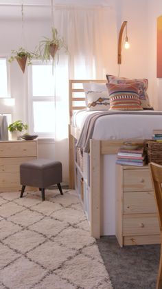 a bed room with a neatly made bed next to a desk and chair in front of a window