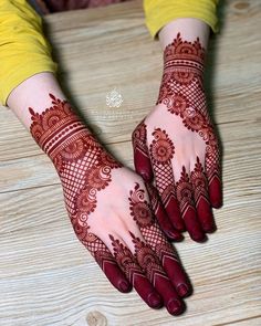 two hands with henna designs on them