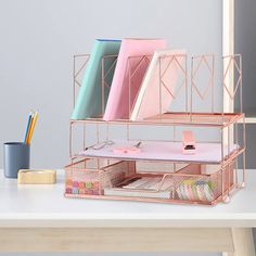 pink and blue office supplies sit on a desk