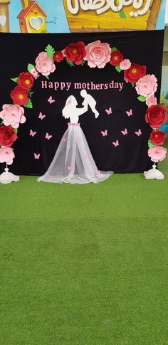 a decorated stage with flowers and butterflies for mother's day at a children's birthday party