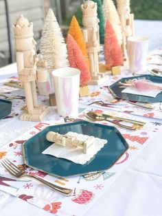 a table set with place settings and napkins