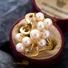 This elegant pearl cluster ring features gorgeous AAA quality white pearls with strong rosé overtones.  The pearls are decorated with swirling goldwork interspersed with diamond accents.  The ring is crafted in 14k yellow gold and is currently a size 6.75. Fine Jewelry Pearl Cluster Ring For Wedding, Cluster Pearl Wedding Ring, Elegant Cluster Pearl Ring For Formal Occasions, Wedding Pearl Cluster Ring, Wedding Cluster Pearl Ring, Elegant Formal Cluster Pearl Ring, Elegant Cluster Pearl Ring Gift, Elegant Cluster Pearl Ring As A Gift, Pearl Cluster Ring