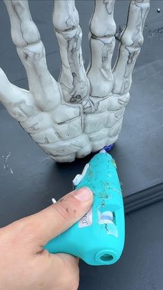 a hand that is next to a blue object