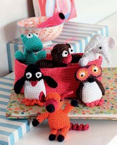 crocheted toy animals sitting on top of a table