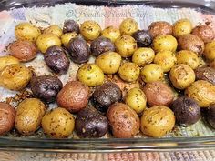 roasted herb baby potatoes in a glass dish on a towel with the words roasted herb baby potatoes