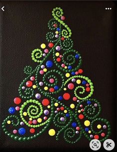 a christmas tree made out of beads on a black background