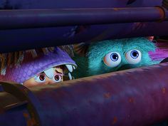 two cartoon characters peeking out from behind a pipe