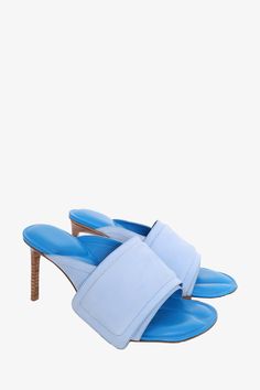 Jacquemus Blue Leather 'Les Mules Aqua' Heeled Sandals. Slip-on. Round open toe. Tonal stitching Original Retail Price: $750Size: 37 IT (7 US)Heel Height: 3.25Condition: This item is in fair pre-loved condition with visible signs of wear throughout. Wear on sole. Minor discolouration and pilling on suede strap. Loose strap seam Luxury Blue Mules, Light Blue High Heel Sandals With Padded Heel, Light Blue Open Toe Sandals For Evening, Light Blue Open Toe Heels With Wrapped Heel, Formal Light Blue Open Toe Sandals, Light Blue Open Toe Sandals With Wrapped Heel, Blue Sandals With Heel And Single Toe Strap, Blue Sandals With Padded Open Heel, Summer Open Toe Heels With Leather Sole