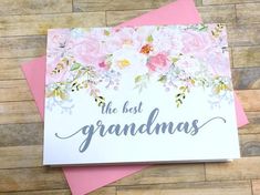 the best grandmas card with pink and white flowers on it next to two cards