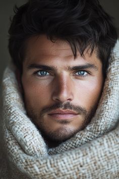 a close up of a person wearing a scarf and looking at the camera with a serious look on his face