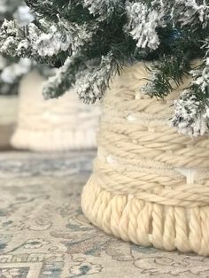 a close up of a rope wrapped planter with snow on the ground behind it