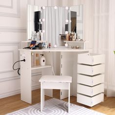 a white dressing table with drawers and lights