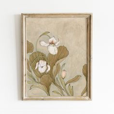 a painting hanging on the wall with flowers painted on it's side and leaves in the middle