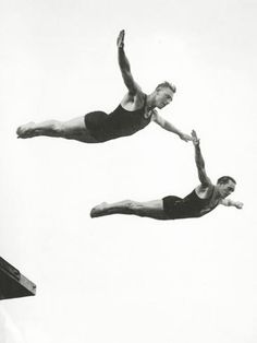 two men are performing acrobatic tricks in the air